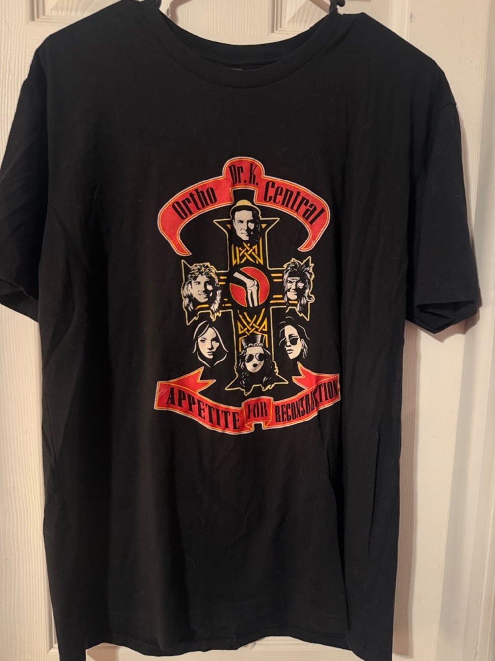 Next Level Apparel Black Graphic Tee with Red and Gold Band Emblem